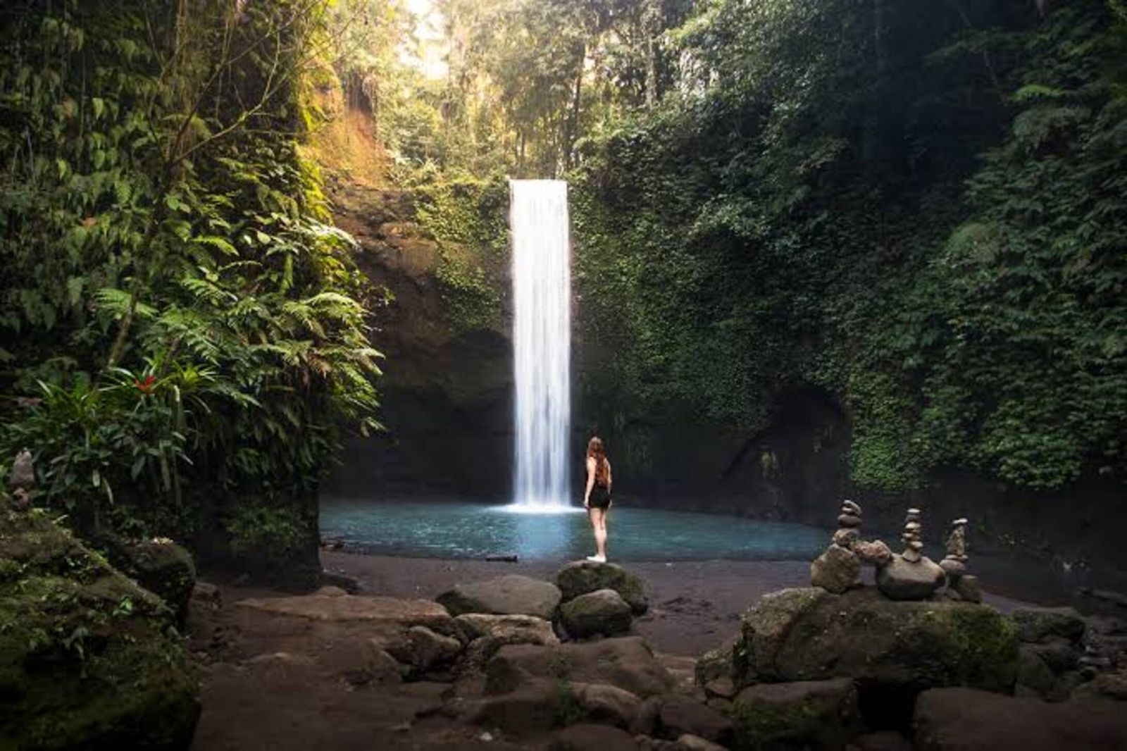 Adventure seeker at stunning Bali waterfall surrounded by tropical nature